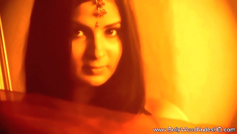Indian girlfriend seduces a sexy brunette in a bedroom