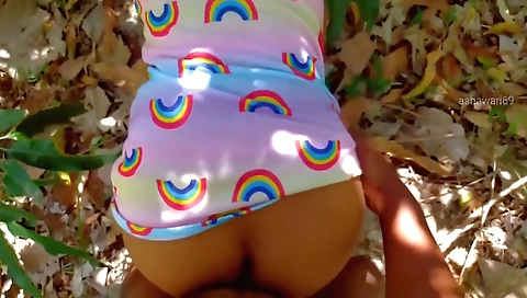 Brunette in sexy clothes playing with a toy outdoors