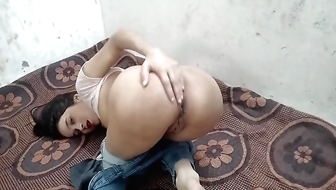 Sexy petite chacha girl in white blouse sits on the floor