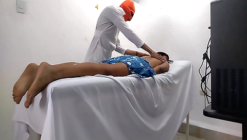Indian massage instructor gives a massage to a client