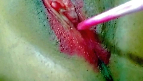 Indian girl masturbates on a bed with a red lip gloss